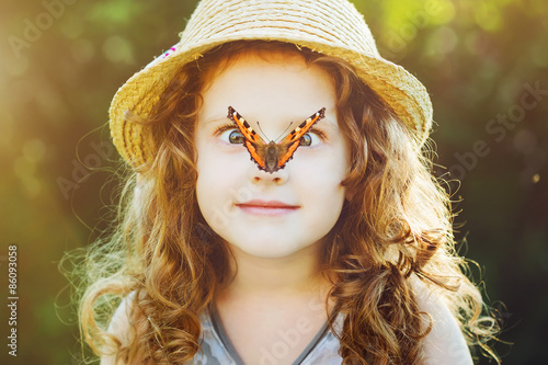 Surprised girl with a butterfly on her nose. Toning to instagram photo