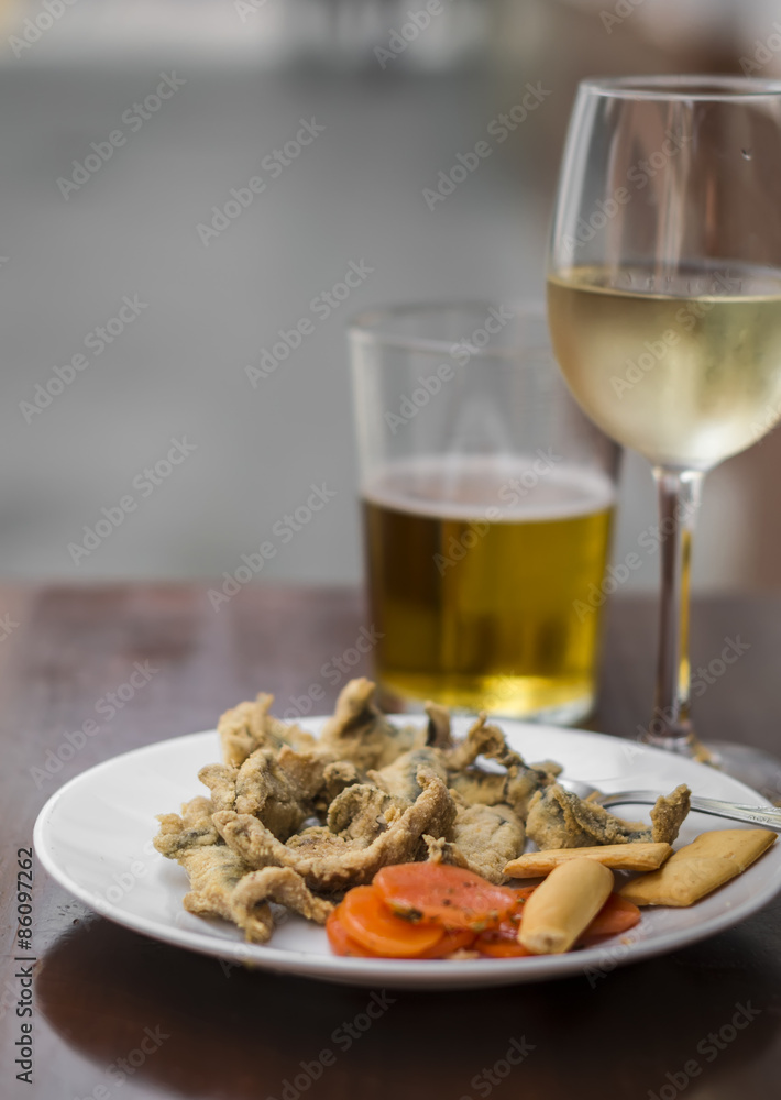 fried anchovies, white wine and beer at a street bar, Seville, Spain fried anchovies, white wine and beer at a street bar, Seville, Spain