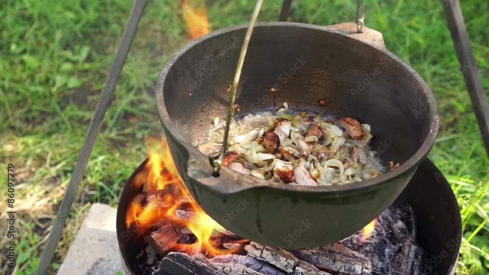 Cooking in metal pan on campfire Cooking in metal pan on campfire