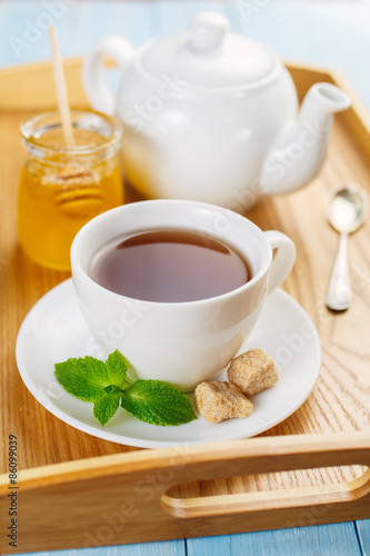 Cup of black tea with mint and honey 