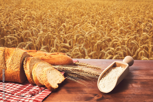 Bread wheat and flour on the table photo