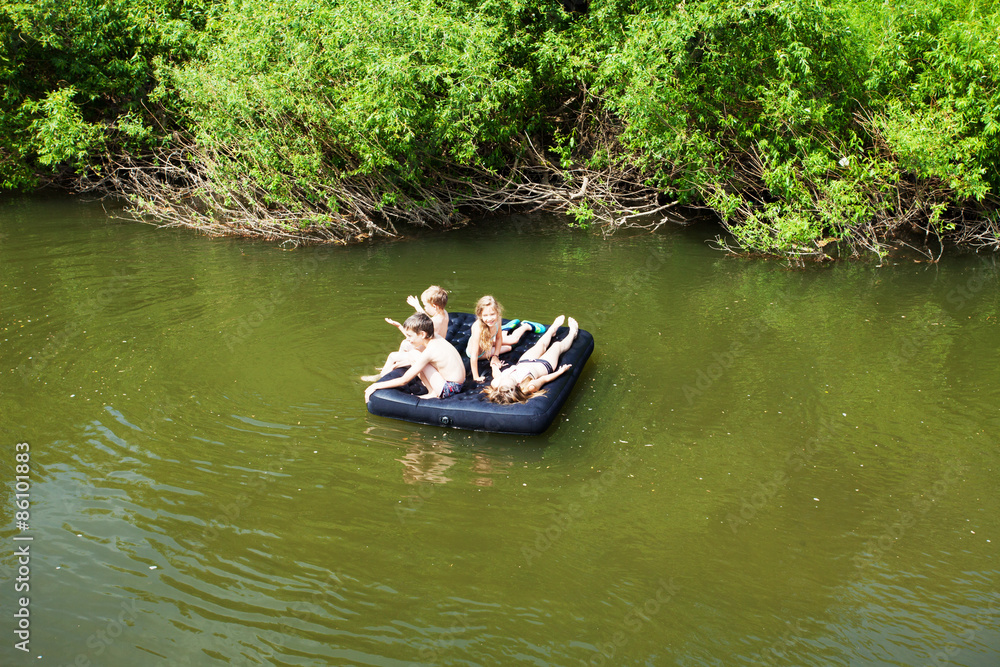 Children floating on the river