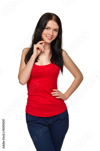 Smiling casual female in jeans and red tshirt standing relaxed w