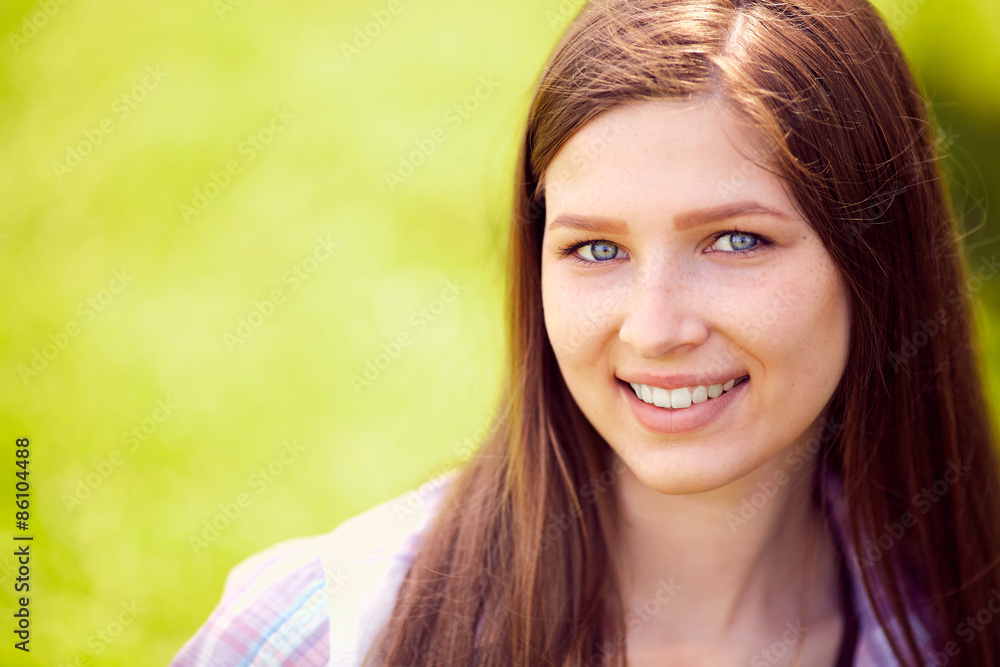 Fototapeta premium Attractive young woman enjoying her time outside in park with su