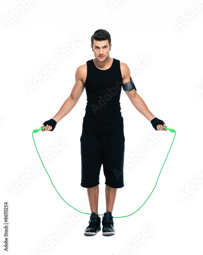 Handsome man working out with skipping rope