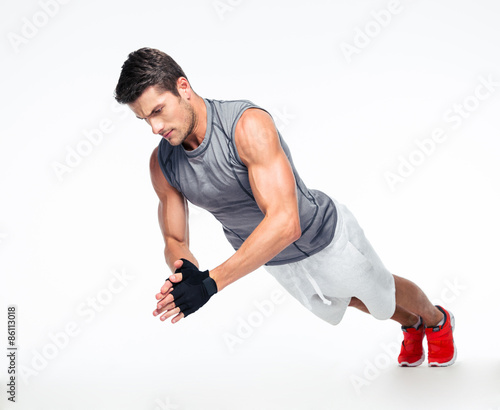 Fitness man doing exercises on the floor