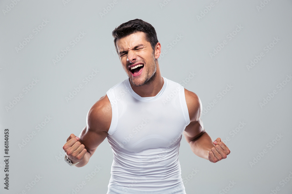 Muscular man celebrating his success Muscular man celebrating his success