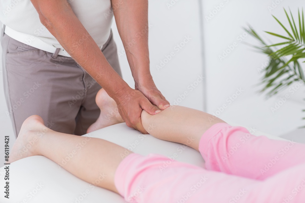 Fototapeta premium Physiotherapist doing calf massage 