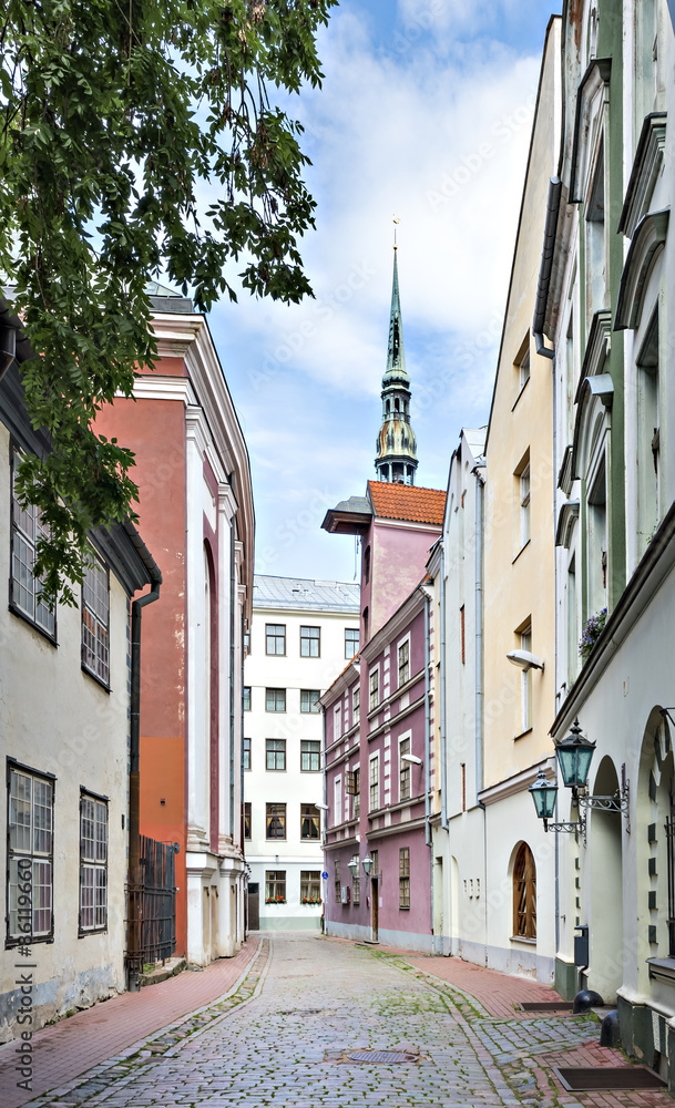 Fototapeta premium Narrow medieval street in the old Riga city, Latvia. The photo may be used for advertising agencies for popularization of tourism in Latvia 