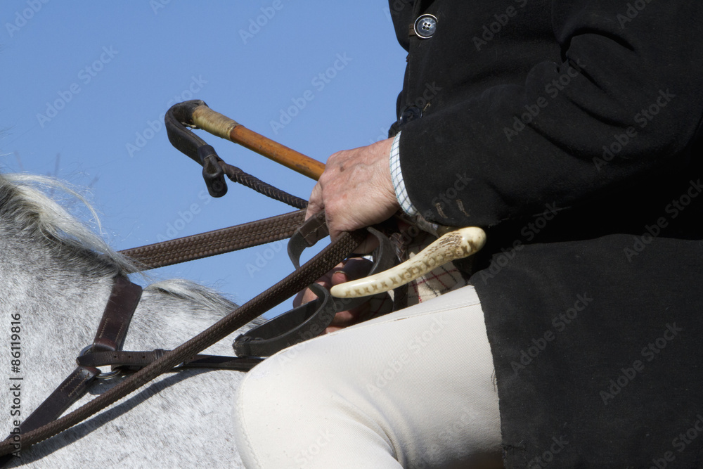 riding crop seated on horseback. Stock 