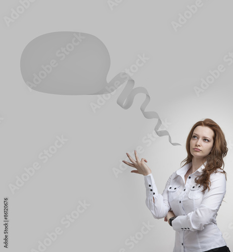 Business woman and blank speech bubble on gray background.