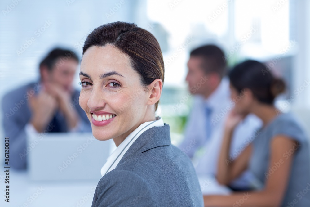 Fototapeta premium Smiling businesswoman looking at camera