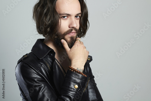 young bearded man in a leather. Hipster.handsome boy