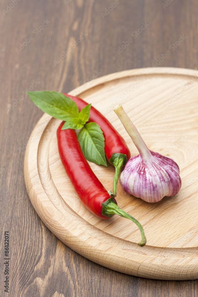 Red chilli pepper with green basil on wooden board Red chilli pepper with green basil on wooden board