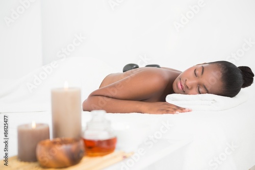 Peaceful pretty woman enjoying a hot stone massage
