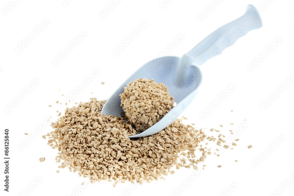 Plastic scoop for cleaning cat litter and a pile of filler on a Plastic scoop for cleaning cat litter and a pile of filler on a