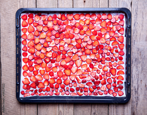 fruit. Strawberry baking on a dark metal plate in oven