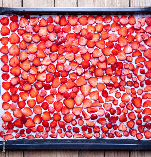 fruit. Strawberry baking on a dark metal plate in oven