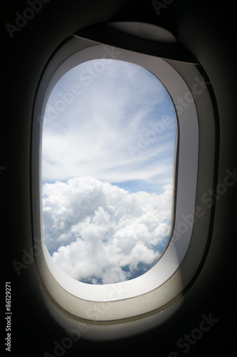 Looking out the window of the plane  and then view the sky.