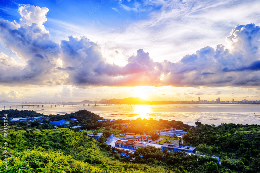 Village with beautiful sunset over hong kong  coastline.