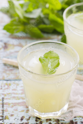 Two glass of fresh lemonade decorated with mint leaves