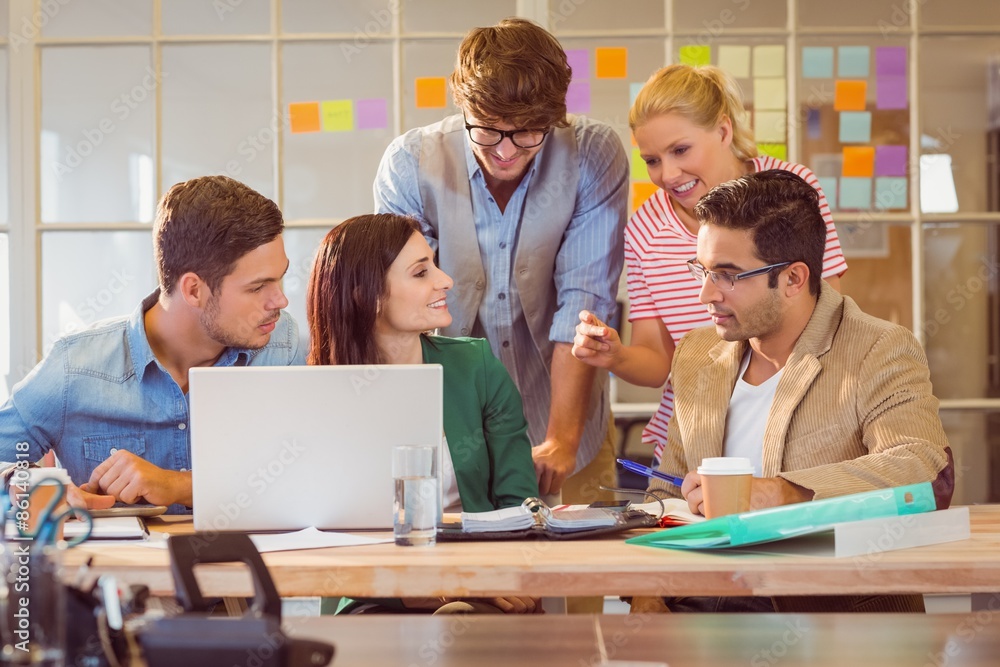 Happy creative business team using laptop in meeting Happy creative business team using laptop in meeting