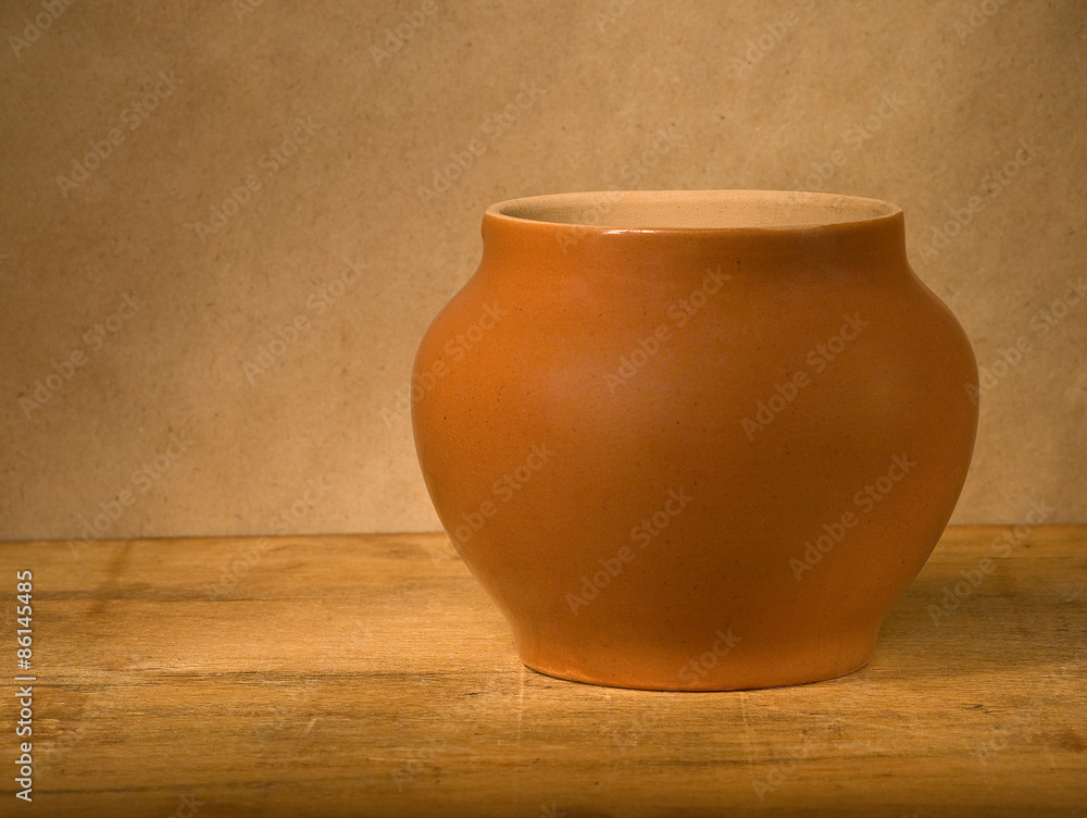 Clay pot on wooden table. Clay pot on wooden table.