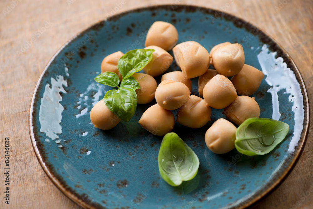 Close-up of mini provoleta balls with green basil on a plate Close-up of mini provoleta balls with green basil on a plate