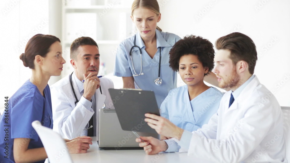 group of doctors with clipboard talking at clinic group of doctors with clipboard talking at clinic