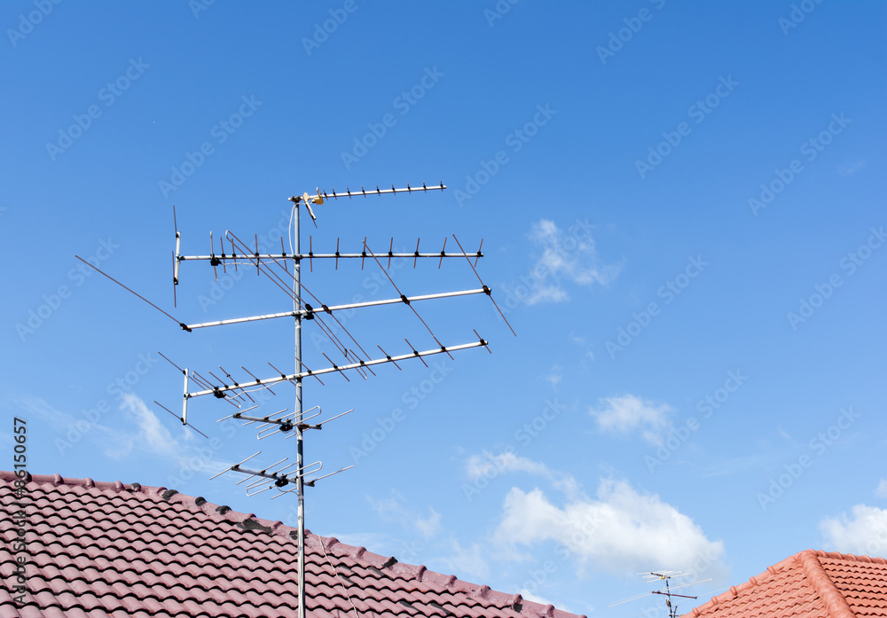 television antenna on roof with blue sky television antenna on roof with blue sky