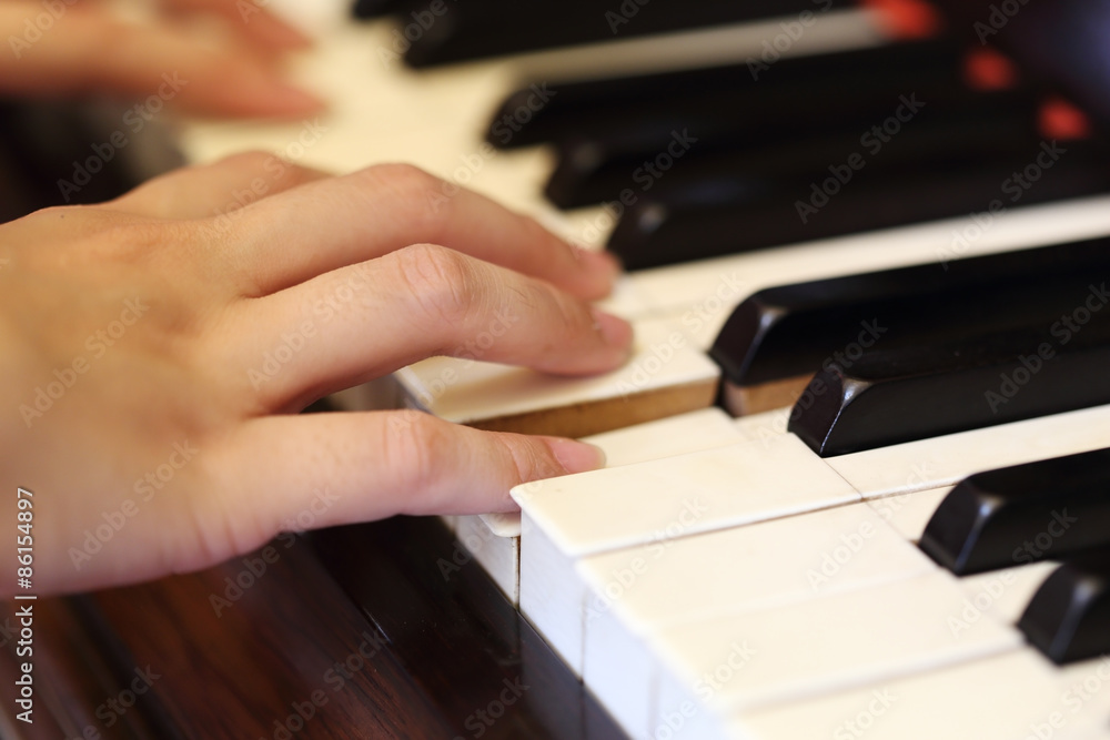 hands playing the classic wood  piano