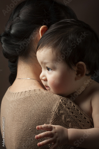 baby on her shoulder