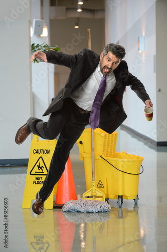 Konstfotografi Businessman Falling on Wet Floor