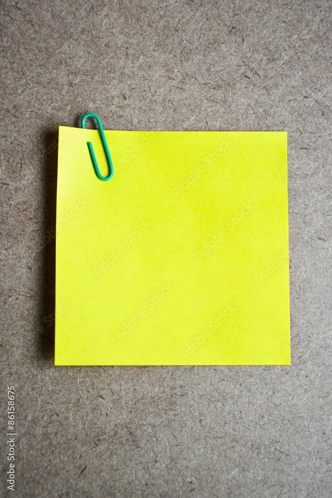Yellow note paper on wooden background. Yellow note paper on wooden background.