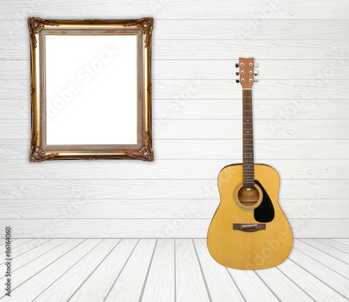 Guitar and picture frame in room © geargodz