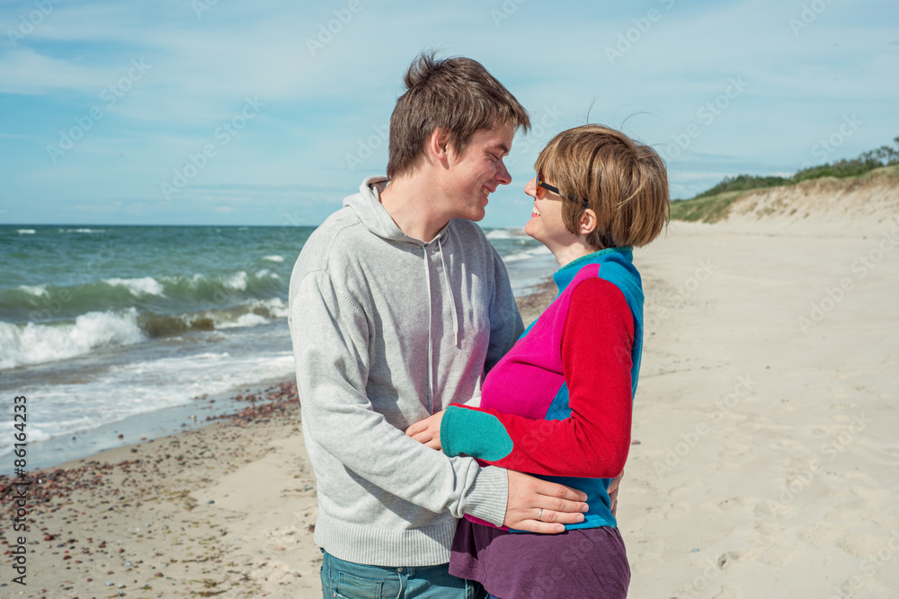 Young man and woman looking at each other on the beach Young man and woman looking at each other on the beach