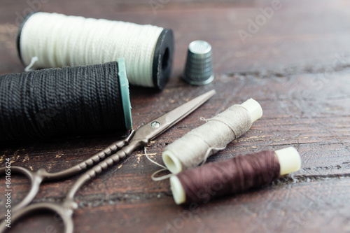 Sewing tools on the old wooden background