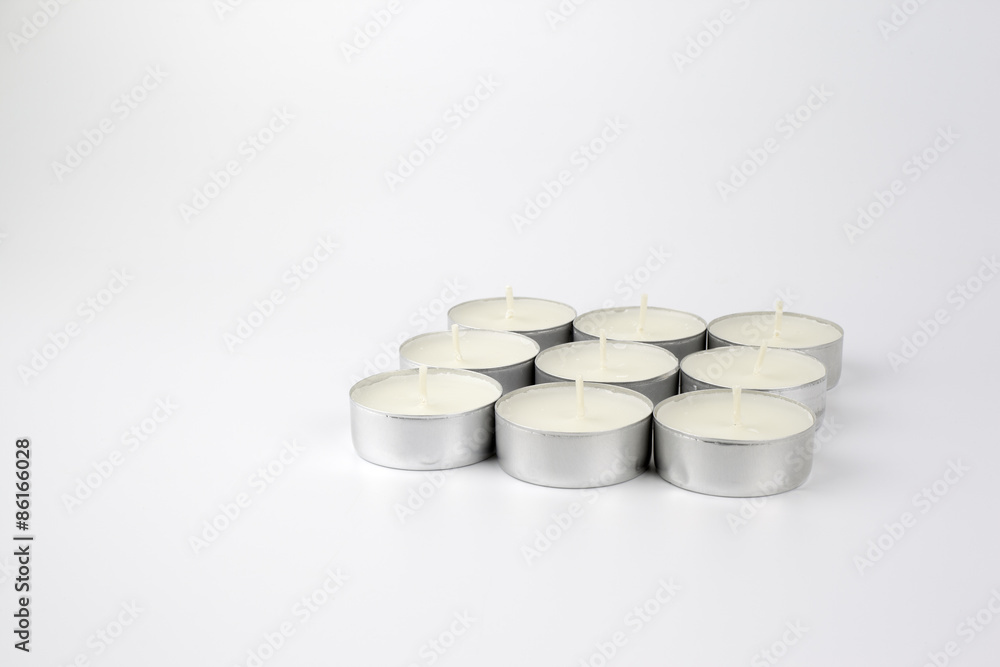 Paraffin candles tea on a white background - free space for text Paraffin candles tea on a white background - free space for text