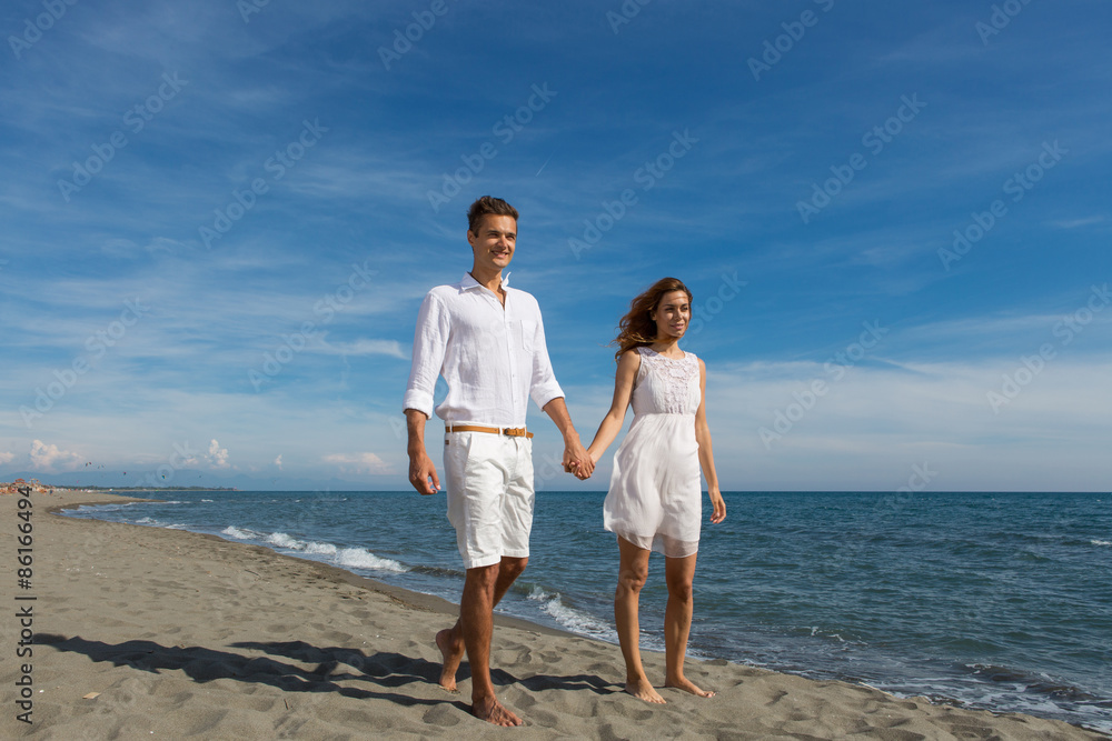happy couple in love walking on the beach