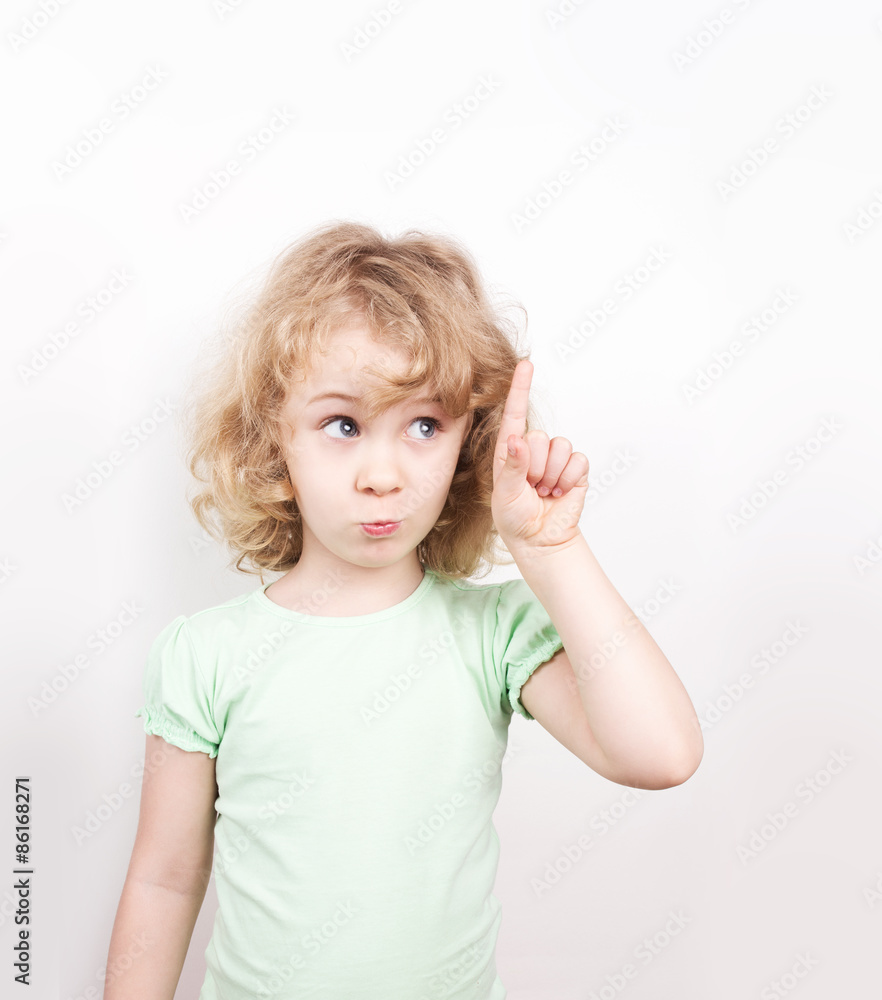 Cute little girl pointing up, copy space Cute little girl pointing up, copy space