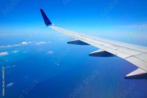 Airplane wing with blue sky