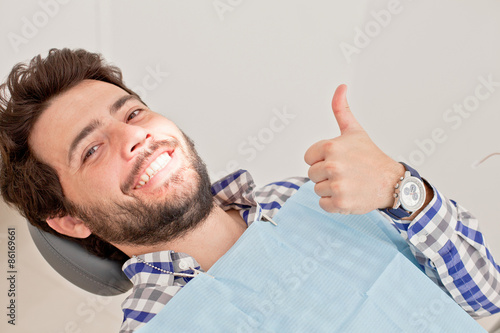 young happy man and woman in a dental examination at dentist