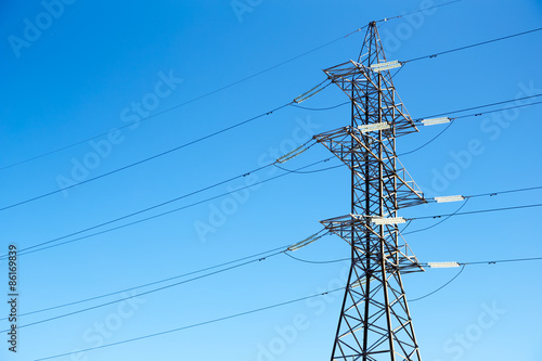 High voltage power lines against the blue sky