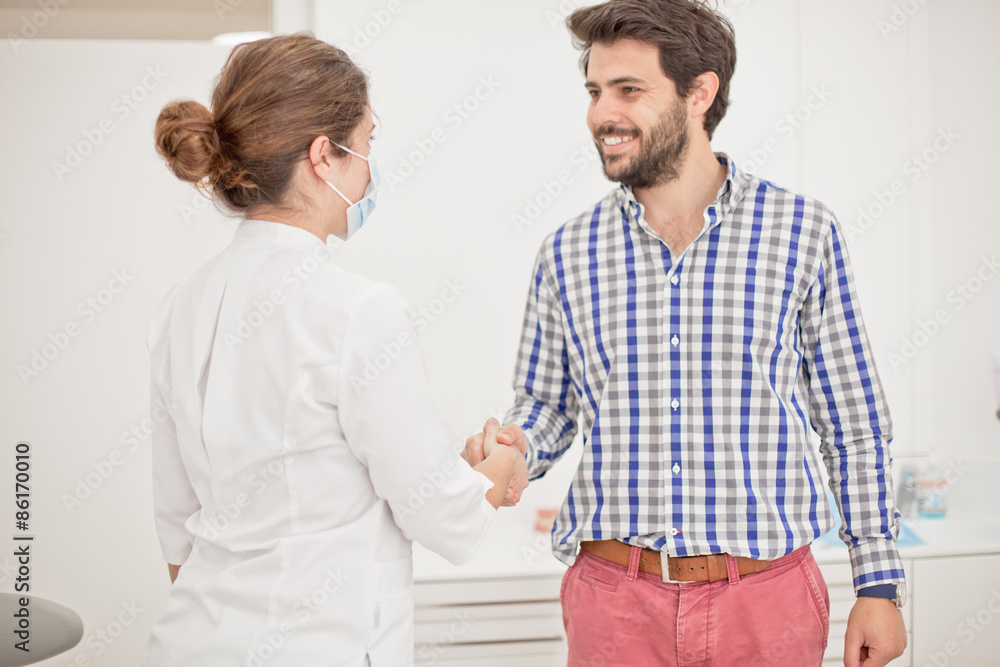 young happy man and woman in a dental examination at dentist young happy man and woman in a dental examination at dentist