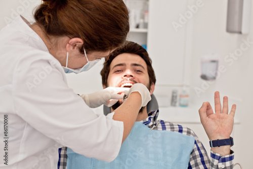 young happy man and woman in a dental examination at dentist