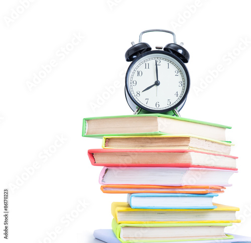 Alarm clock and stack of books