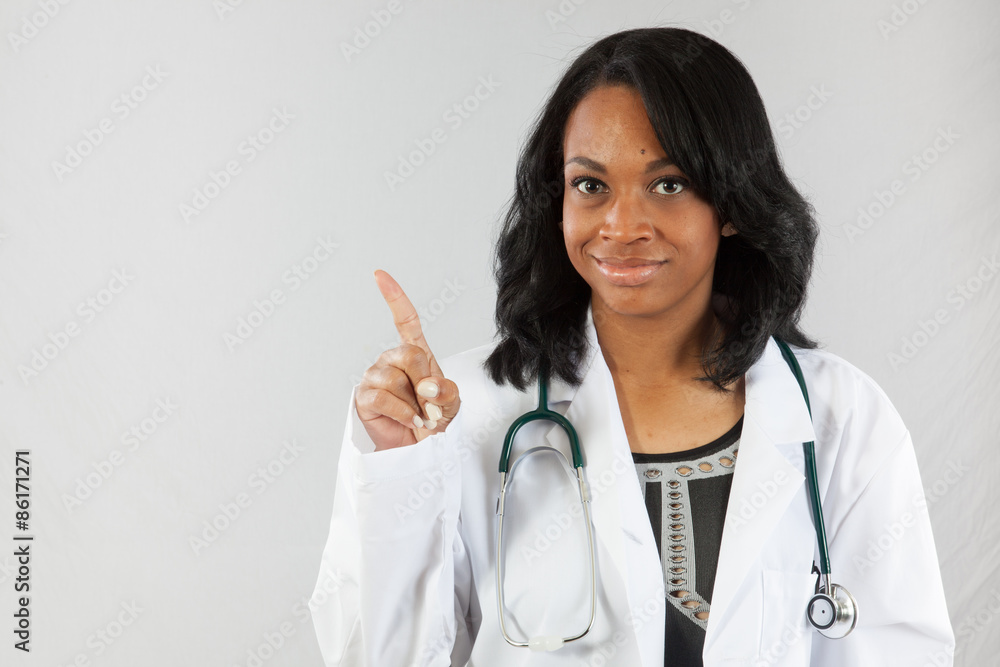 Black woman in lab coat and stethoscope, writing Black woman in lab coat and stethoscope, writing