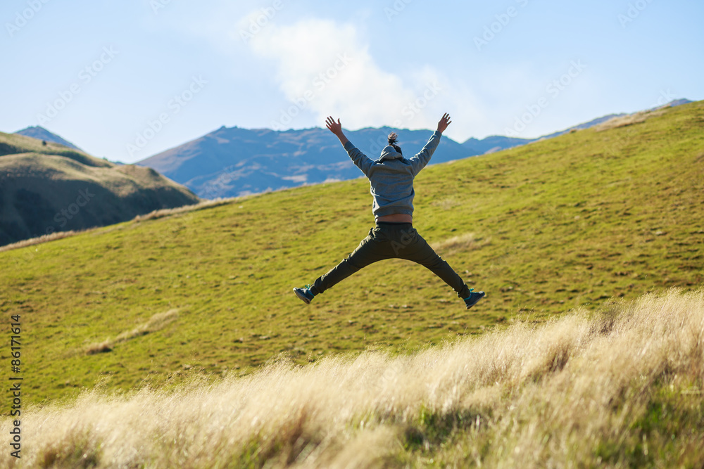 young adult man jumping on meadow young adult man jumping on meadow