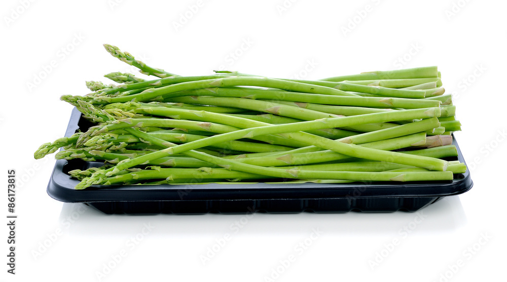 asparagus in black plastic tray on a white background asparagus in black plastic tray on a white background
