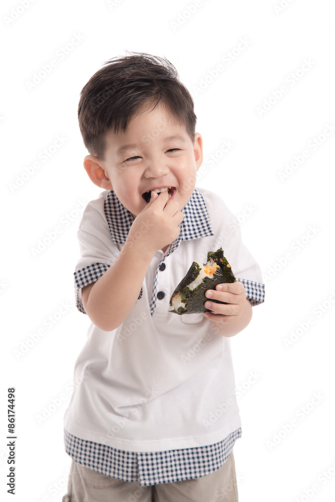 Cute asian child eating rice ball or onigiri Cute asian child eating rice ball or onigiri